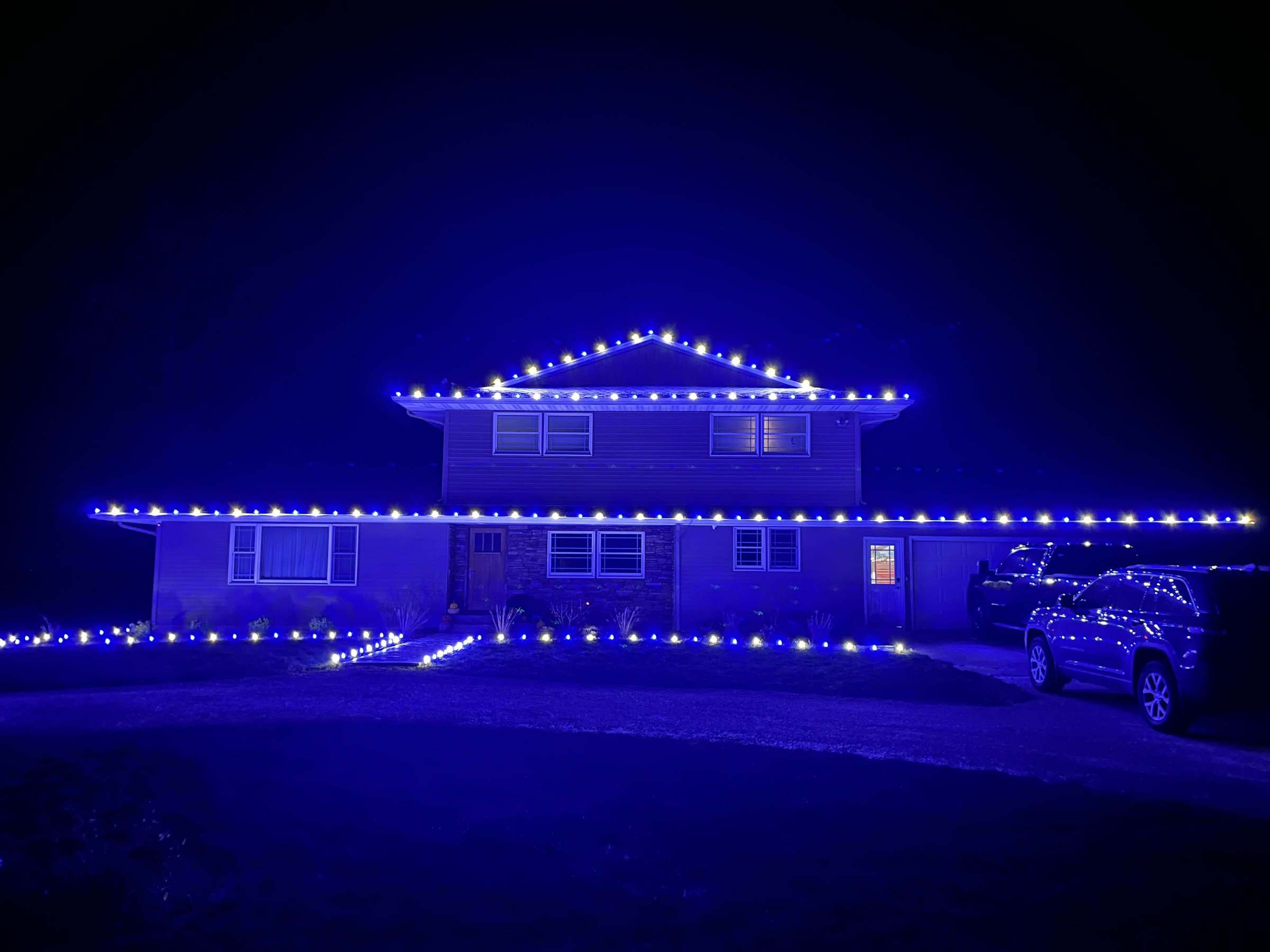 Professionally installed warm white Christmas lights on a home like those we light in Sullivan, Illinois