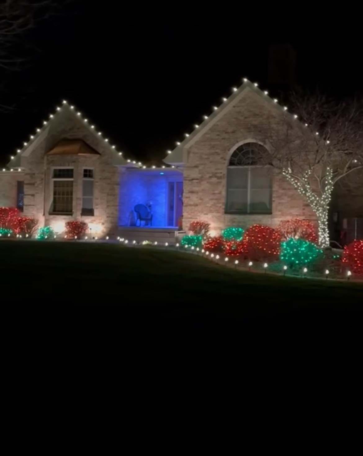 Professionally installed warm white Christmas lights on a home like those we light in Gibson City, Illinois