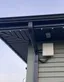 Weatherproof controller box mounted on siding under a soffit