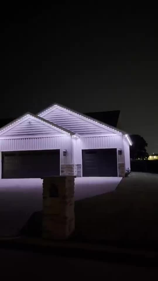 Permanent roofline lights in orange and purple on a home during October