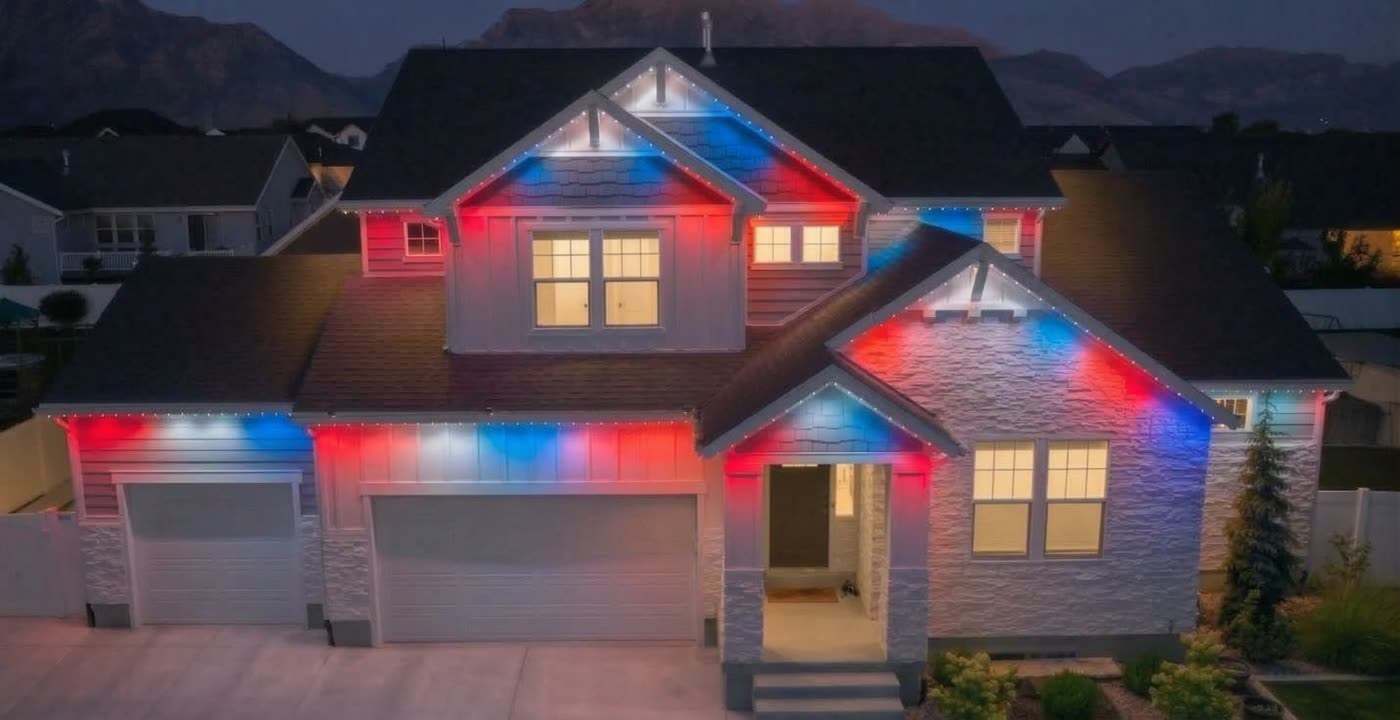 Home with permanent roofline lights in red, white and blue for the Fourth of July